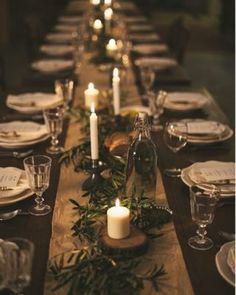 a long table is set with candles and place settings for the dinner guests to enjoy