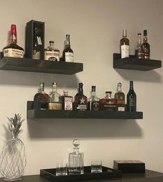 two shelves with liquor bottles and glasses on them