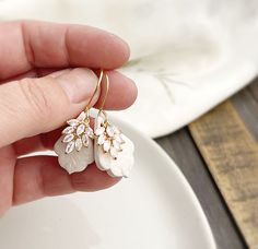 "Bridal Earrings * Neutral White and Gold CZ Earrings * Bridesmaids Handmade Polymer Clay  Teardrop Earrings 1/2\" gold plated cz leaf drop accents hand formed 1 1/2\" white polymer clay teardrop.  The white clay has a beautiful floral pattern.  Each one is unique!   They hang from gold plated stainless steel earwires. They measure about 2\" from the top of the ear wire to the bottom of the clay drop." Nickel-free White Crystal Earrings For Wedding, White Polymer Clay, Bridesmaid Earrings Gold, Polymer Clay Jewelry Tutorials, Handmade Clay Jewelry, Jewellery Ideas, Earrings Elegant, Cz Earrings, Handmade Clay