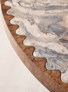 a close up view of a marbled table with wavy lines on the top and bottom