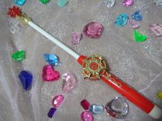 a red toothbrush sitting on top of a table next to some candies and other items