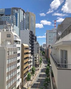 an empty city street with tall buildings in the background