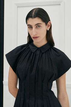 The signature Unchartered shirt dress in Cotton returns, in the much anticipated Black colour this season. Find out why so many have fallen in love with this style, with its uniquely tapered box pleats at the waist, giving the dress a flattering silhouette. The style also features open shaped sleeves and a concealed button front opening and side pockets for ease of wear. Colour: Black Also available in Ivory and Lilac colour-ways. Fit: Regular fit overall, slim fitting at waist.Model is wearing Long Dress Style, Black Dress Style, Bauhaus Architecture, Fashion Trend Report, Lilac Colour, Garment Care Labels, Classic Black Dress, Colour Ways, Pleated Shirt