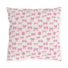 a pillow with pink bows on it