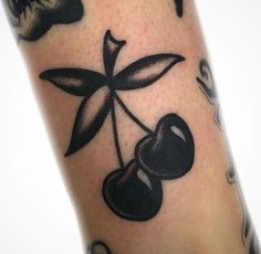 a tattoo with an olive on the leg