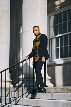 a man is standing on the steps in front of a building