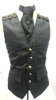 #C2/1This is 3 pcs Waistcoat outfit with 12 brass old fashioned Buckles on Shoulder Details.Cravat and tie pin.Waistcoat has 4 Sides pocket and brass buttons and waist adjuster at the back.It is fully lined.Self tie cravat is same fabric as waist coat with brass compass tie pin included.Please refer to photos.Waistcoat is Available in M40”L/42” XL/44”XXL/46”SizeXXL - To Fit chest 46” (armhole To armhole 48”)Front Length - 25” approximately Back length - 24” approximately Thank you for looking Gothic Black Vest For Costume Party, Gothic Black Vest For Costume, Black Gothic Costume Vest, Black Steampunk Vest For Costume Party, Steampunk Black Vest For Costume Party, Steampunk Style Black Vest For Costumes, Black Fitted Steampunk Vest, Fitted Striped Business Vest, Black Fitted Vest For Cosplay