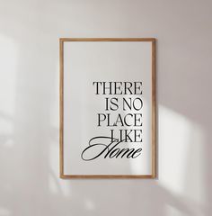 there is no place like home framed art print on the wall in a room with white walls