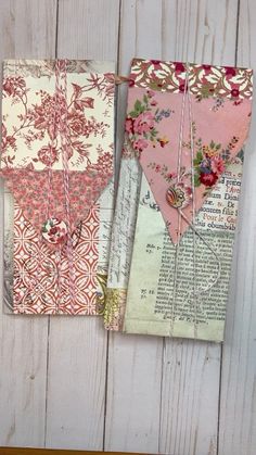 three pieces of paper are hanging on a white wooden wall with pink and red flowers