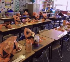 a classroom filled with lots of desks covered in plastic bags and wrapped food items