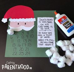 some cotton balls and glue are next to a santa's hat on a table