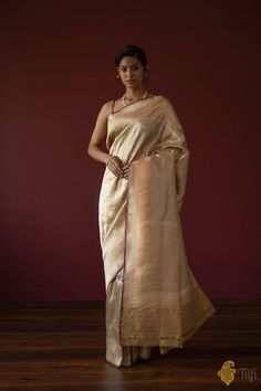 "With its rich floral web of zari, this regal\u00a0saree is truly representative of the royal clothing traditions of India. A luxurious piece of handwoven art!\n\n\n\nColor\u00a0- A\u00a0charming shade of Pale Yellow\n\nTechnique\u00a0- Classic handwoven Banarasi Zari Vasket art passed down through generations\n\nFabric\u00a0- Soft as butter, pure Katan Silk\n\nSpeciality\u00a0- A beautiful floral web of zari all over\u00a0the body and a rich border and pallu. Age-old Banarasi artistry.\u00a0\n\nTilfi Promise\u00a0- Pure. Handloom. Banaras.\n\nNote\u00a0- The saree comes with its own blouse piece. The\u00a0model is wearing a separate blouse for styling purposes.\n\n\n\u00a0\nSince\u00a0this product is handwoven, there might be slight irregularities. But don't you think these add to the sin Regal Saree, Royal Clothing, Katan Silk, Indian Outfit, Art Color, Handloom Saree, Pale Yellow, Blouse Piece, Fashion Drawing