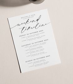 the wedding stationery is set on top of a table with a coffee cup and pen