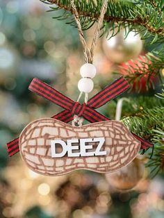 a christmas ornament hanging from a tree with the word deez on it