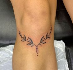 a woman's leg with a tattoo design on the lower part of her body