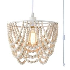 a white light fixture with beads hanging from it's side and an electric cord attached to