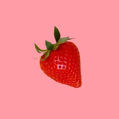 a single strawberry on a pink background with the word love spelled in it's center