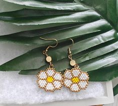 ☀️These hand beaded Daisy Earrings were made with colorful seed beads some of which are 24 Karat gold. 🌼 Perfect for the summer or on vacation! ☀️ LOCAL PICK UP NOTE: THIS IS AVAILABLE FOR LOCAL PICK UP!  JUST SEND US A MESSAGE BEFORE YOU BUY IF YOU ARE LOCAL! CUSTOM ORDERS Would you like a custom order? Something similar but in a different size or color? Contact me and we can figure it out together - I love creating custom items so please don't hesitate to ask. Please allow 2-3 weeks from the date you submit payment for your custom order to be created and shipped. We will keep in contact through email so you can see the progress of your custom item. If your item is already made, allow 1-3 days for delivery. Visit the shop here: https://www.etsy.com/shop/martiancreations?ref=hdr_shop_menu Beaded Daisy Earrings, Beaded Flower Earrings, Beaded Daisy, 24 Karat Gold, Handmade Earrings Beaded, Daisy Earrings, Earrings Beaded, Colored Contacts, Raleigh Nc