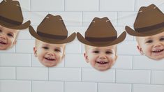 three little boys wearing cowboy hats hanging from a line with paper cutouts on them