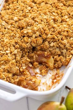 a casserole dish with apples and oatmeal crumbled on top