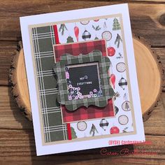 a close up of a greeting card on a wooden table with a wood slice in the background