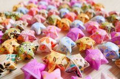 small colorful origami stars on a wooden surface