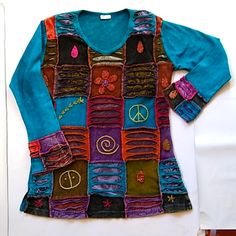 Gorgeous Boho Patch Work Sweatshirt. Hippie Chic Patchwork / Granny Square Design. Adorned With Peace Sign, Daisy, Stars And More. Turquoise Blue, With Multi Color Patches. Great Retro 60's Bohemian Vibe. Fabric Weight Is A Thick T-Shirt Or Light Sweatshirt. Indiana Boutique V-Neck Long Sleeves 100% Cotton Top Is "One Size" Bust Across: 21" Length: 30" Nwot - New Without Tag's Blue Cotton Patchwork Tops, Blue Patchwork Crew Neck Top, Blue Patchwork Top For Winter, Winter Blue Patchwork Top, Colorful Patchwork Top For Fall, Blue Crew Neck Patchwork T-shirt, Blue Crew Neck T-shirt With Patchwork, Multicolor Long Sleeve Hippie Tops, Purple Patchwork Long Sleeve Top