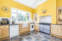 a kitchen with yellow walls and white appliances