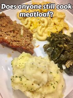 a white plate topped with meat, mashed potatoes and greens next to macaroni and cheese