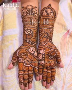 two hands with henna designs on them