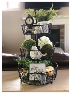 three tiered baskets with plants and decorations