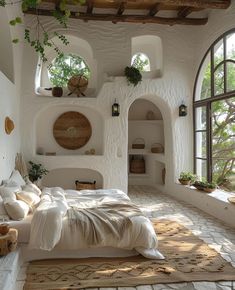 a bedroom with an arched window and bed in the middle, surrounded by plants on either side