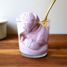 a glass filled with ice cream on top of a wooden table