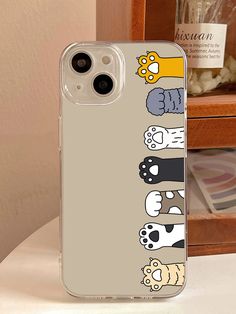 an iphone case with cartoon characters on the front and back cover, sitting on a table