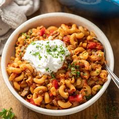 a white bowl filled with pasta and sour cream