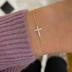 Our Esther Dainty Diamond Cross Bracelet is a glimmering beacon of faith. Stylish and elegant, this bracelet embodies the beauty of His grace. Perfect to shine on its own but sophisticated enough to add to a stack. The intentional delicacy of this design makes for the heartfelt gift of a child's first piece of fine jewelry or an adult's everyday dainty wear. Metal: 18k White Gold / 18k Yellow Gold / 18k Rose Gold Round Brilliant Cut Natural Diamonds: Approx. 0.10 ctw G Color and SI1-2 Clarity Diamonds Length: 7 inches at the longest. ﻿Adjustable sliding bead to provide options for smaller wrist size. Closure: Lobster clasp Measurements: Approx. 11.7mm length x 5.9mm width Looking for a different size? Please email us. Elegant Yellow Gold Cross Rosary Bracelet, Fine Jewelry Vvs Clarity Bracelet As Gift, Elegant Yellow Gold Rosary Bracelet With Cross, Elegant White Cross Bracelets, Elegant White Cross Bracelet, Yellow Gold Sterling Silver Tennis Bracelet As Gift, Elegant Cross Rosary Bracelet For Wedding, Elegant Sterling Silver Cross Rosary Bracelet, Elegant Cross-shaped Rosary Bracelet For Wedding