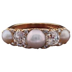 Victorian Statement This stunning Victorian era ring is extremely well crafted of solid 18 Kt, finest details crisp and rich for the scroll work delineating the half hoop design, 1880 ca Classy five stone ring as for Victorian tradition, high in quality, set with a selection of Natural not nucleated t salt water split Pearls ranging in sizes from 7 to 5 mm. beautiful glow and silky sheen Interspaced by 2 old mine cut Diamonds of 1.80 Ct for both stones – superb chunky cut and true quality– rated G VVS/VS with 8 further Diamonds in accent punctuating in between The ring is a classy for engagement or anniversary, very rare and sought after Crown is 7.5 x 24 mm h. x w. with 5.5 grams gross weight Fine condition keeping with age Unless otherwise stated boxes are for presentation only Further D Luxury Pearl Ring With Center Stone For Anniversary, Luxury Exquisite Pearl Ring For Anniversary, Luxury Vintage Oval Pearl Ring, Luxury Vintage Pearl Ring With Center Stone, Luxury Multi-stone Heirloom Pearl Ring, Luxury Multi-stone Pearl Ring In Fine Jewelry Style, Luxury Vintage Gold Pearl Ring, Luxury Antique Diamond Pearl Ring, Luxury Antique Gold Pearl Ring