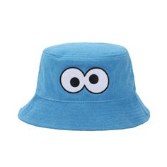 Elevate your sunny days with this adult blue Sesame Street bucket hat featuring the adorable face of Cookie Monster. The one-size-fits-most design, measuring at 59 cm, includes a tie-up inner band for the perfect, comfortable fit. Made with soft polyester terry cloth fabric, this officially licensed hat promises both durability and whimsical style. Hand wash it in cold water and lay it flat to dry for easy care, ensuring Cookie Monster's charm stays vibrant through countless sunny adventures. Blue Cotton Wide Brim Hat, Fun Cotton Bucket Hat For Vacation, Blue Cotton Bucket Hat For Outdoor, Blue Cotton Sun Hat One Size Fits Most, Cute Cotton Bucket Hat For Vacation, Blue Cotton Sun Hat For Outdoor Use, Blue Cotton Sun Hat For Outdoor, Blue Bucket Hat With Uv Protection For Summer, Fun Blue Beach Hat