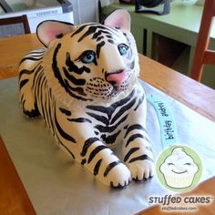 a cake shaped like a tiger sitting on top of a table