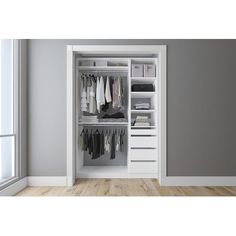 an open white closet with clothes hanging on the doors and shelves in front of it