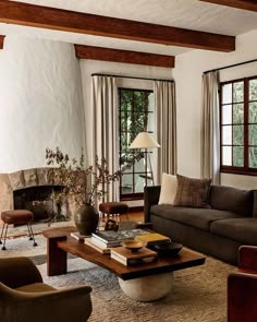 a living room filled with lots of furniture next to a fire place in a fireplace