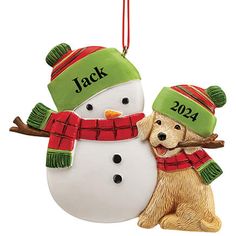 a christmas ornament with a dog and snowman on it's back