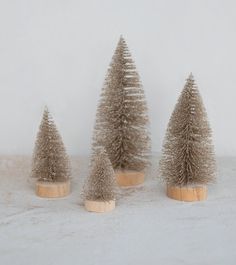 three small christmas trees sitting next to each other