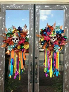 two double doors decorated with colorful ribbons and skulls on the front, one is open