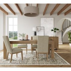 a dining room table with beige chairs and an area rug on top of the floor