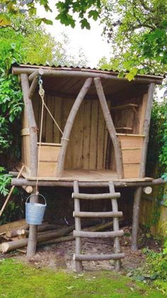 an outhouse made from logs in the yard