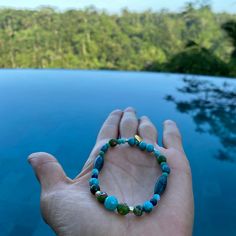 Keep yourself protected with our new twist on Evil Eye bracelets. Beautiful, organic free-form eyes in blue and green beads are made from recycled glass from Jember, Indonesia. According to legend, the evil eye has been around over 5,000 years. The evil eye is a shield that guards against various forms of bad luck or "juju" that is willed onto you or an object by others. Blue Gemstone Fusion Bracelet, Handmade Blue Agate Bracelets, Fusion Style Blue Beaded Bracelets For Gift, Fusion Style Blue Beaded Bracelets Gift, Blue Fusion Style Beaded Bracelets As Gift, Blue Fusion Style Bracelet As A Gift, Blue Fusion Style Bracelet For Gift, Blue Fusion Style Bracelet For Gifts, Blue Fusion Style Bracelet As Gift