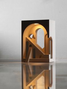 a sculpture is shown with its reflection on the floor