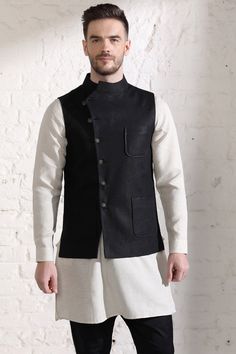 As the name suggests, this Linen Nehru Jacket takes the classic design and puts a designer twist on it. It's asymmetrical style, metallic buttons, and patch pockets are absolutely in-trend right now! Pick it up before it runs out of stock! Luxury Self Design Nehru Jacket For Men, Luxury Self-design Nehru Jacket For Men, Tailored Black Nehru Jacket For Workwear, Classic Fitted Nehru Jacket With Stand Collar, Fitted Nehru Jacket With Pockets For Spring, Fitted Cotton Blazer With Stand Collar, Formal Cotton Nehru Jacket With Long Sleeves, Fitted Cotton Nehru Jacket For Semi-formal Occasions, Cotton Semi-formal Outerwear For Fall