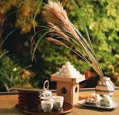 there are some teacups and marshmallows on the table